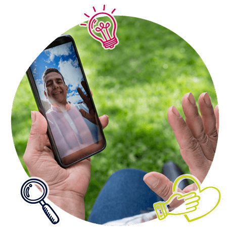 A person waving time a person via video call on a mobile device A person waving time a person via video call on a mobile device